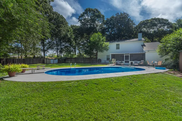 a view of a house with a big yard and sitting area