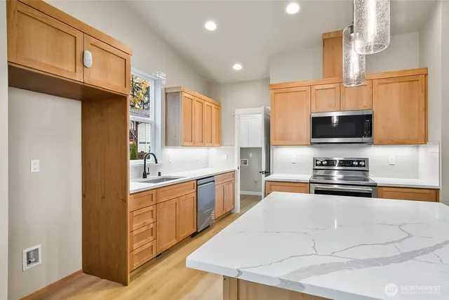 a kitchen with a sink stove and microwave