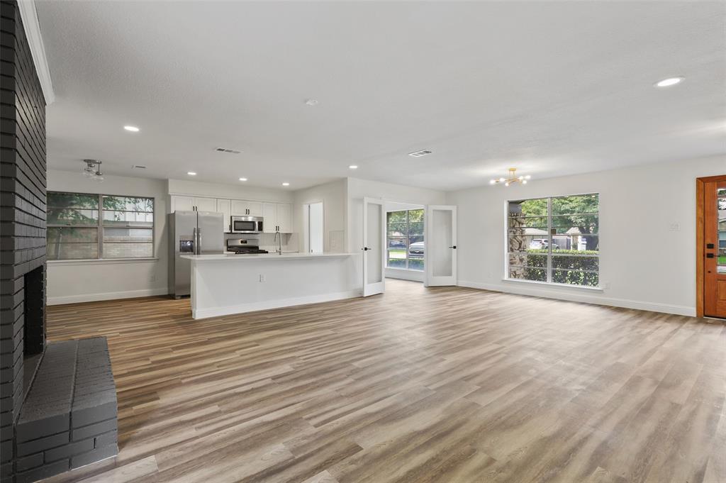 3126 Jubilee Trail Dallas, TX 75229 - Photo 4 of 38 an empty room with wooden floor and windows