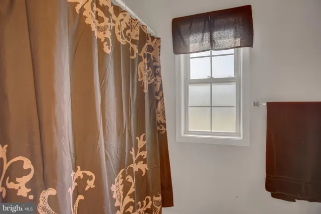 a bathroom with double vanity and two mirror