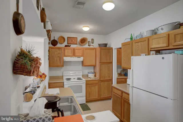 a kitchen with stainless steel appliances granite countertop a stove and a sink
