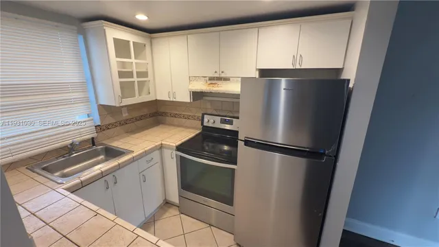 a kitchen with appliances cabinets and a sink
