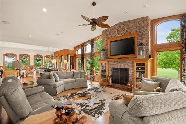 a living room with furniture a fireplace and a flat screen tv