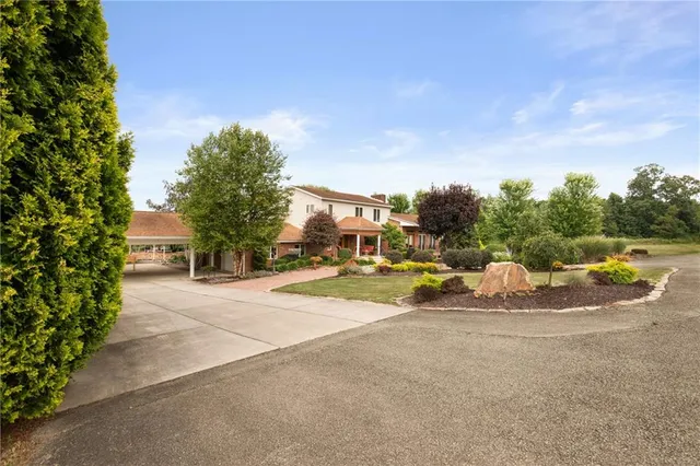 a view of a patio with swimming pool and sitting area
