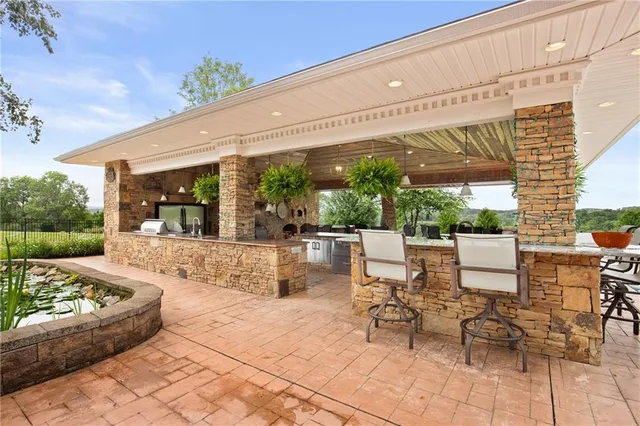 a view of a patio with a dining table and chairs with wooden floor