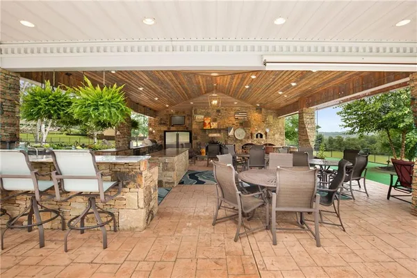 a view of a patio with table and chairs potted plants with wooden floor