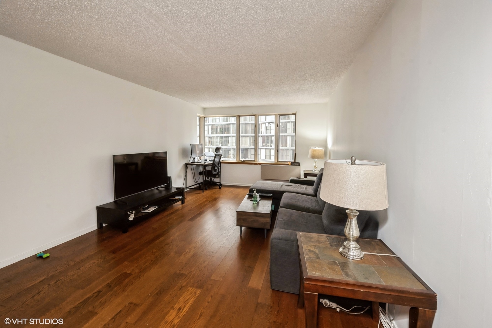 801 South Plymouth Court, Unit 809 Chicago, IL 60605 - Photo 2 of 10 a living room with furniture and a flat screen tv