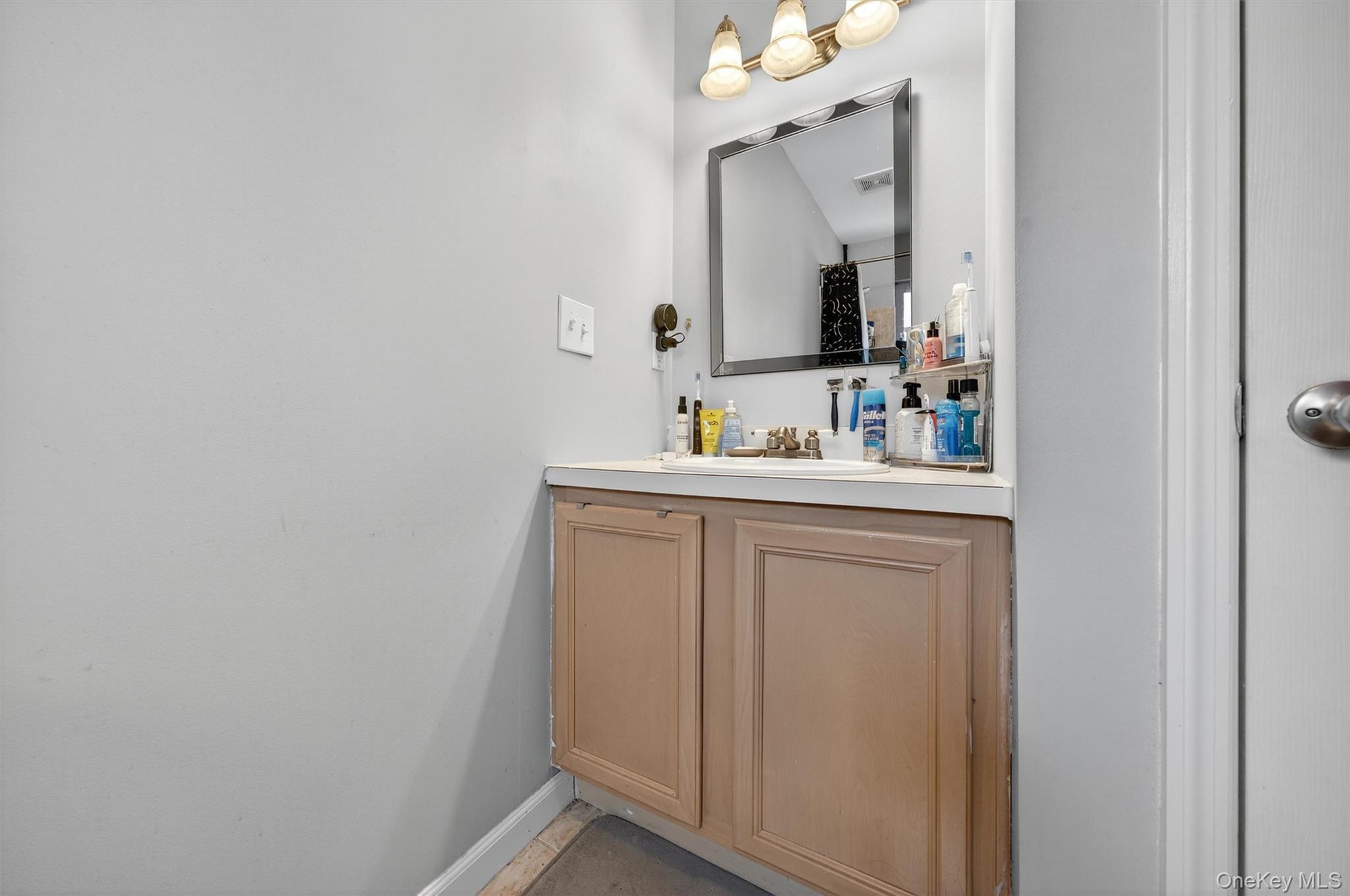 1 Lake Ridge Drive Middletown, NY 10940 - Photo 18 of 44 a bathroom with a sink vanity and mirror