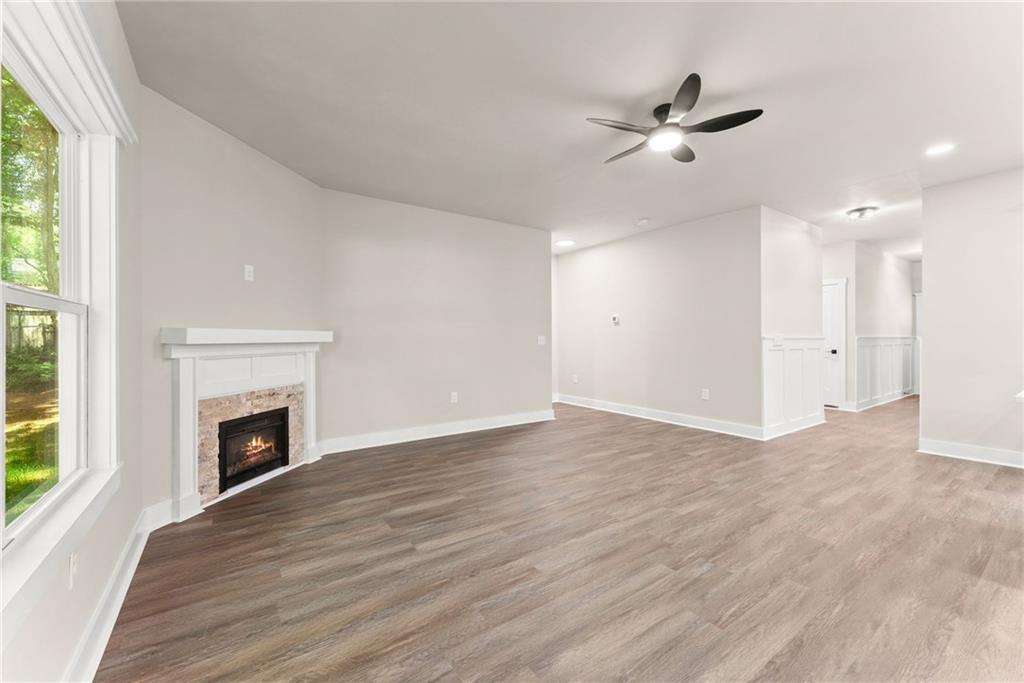 43 Anderson Street Jefferson, GA 30549 - Photo 14 of 45 a view of an empty room with wooden floor fireplace and a window