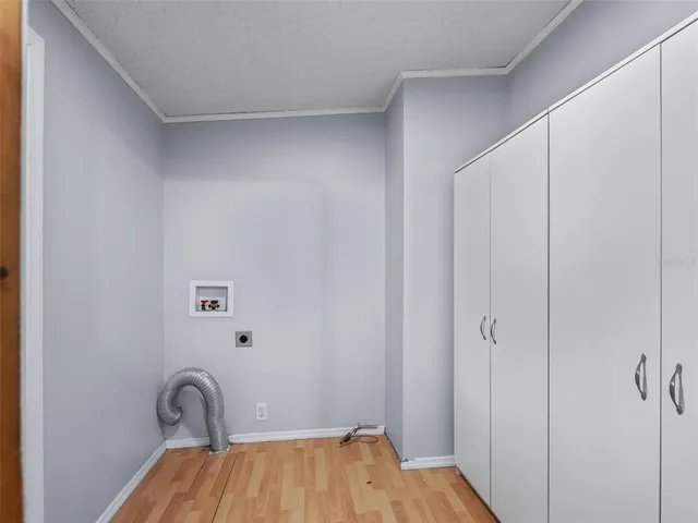 an empty room with ceiling fan and window