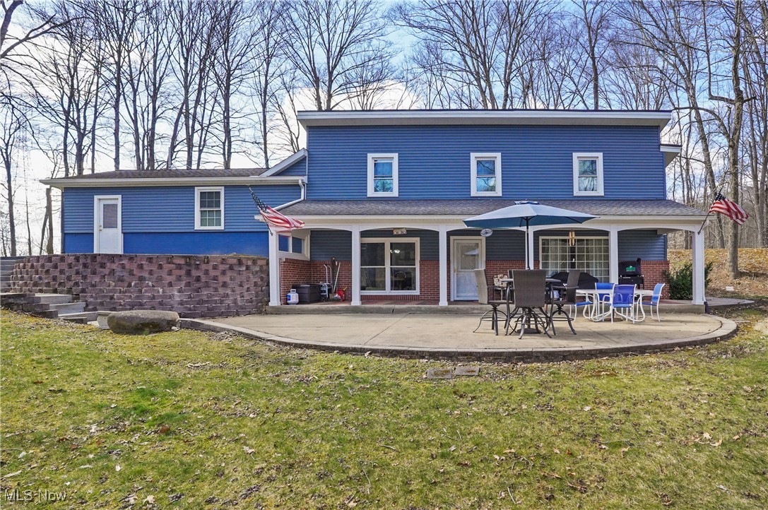 35977 Teegarden Road Salem, OH 44460 - Photo 1 of 50 Back of house featuring brick siding, a lawn, and a patio