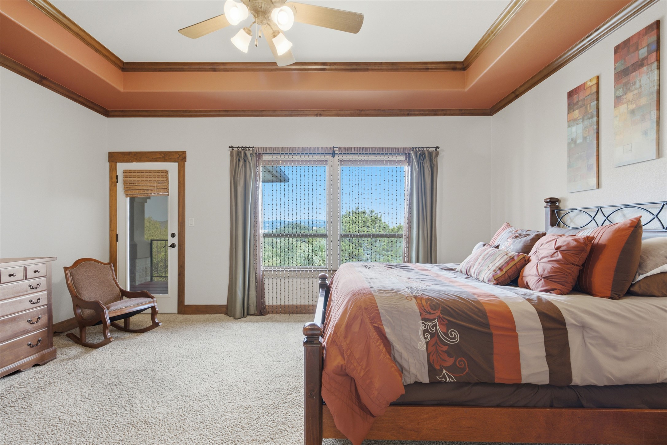 700 Augusta Circle Point Venture, TX 78645 - Photo 9 of 35 A spacious primary bedroom features a private balcony and a scenic outdoor vista.