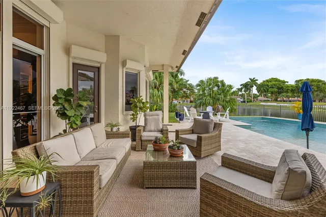 a living room with furniture and a floor to ceiling window