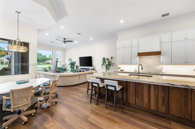 a living room with furniture a flat screen tv and a large window