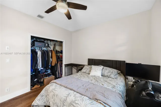 a view of walk in closet with clothes and shoes
