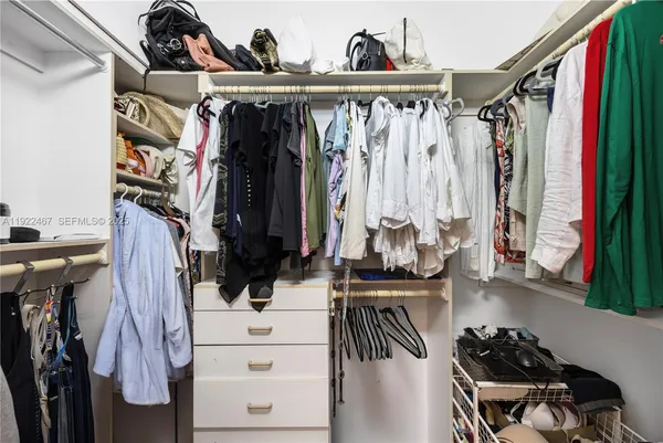 an aerial view of a house with a yard and lake view
