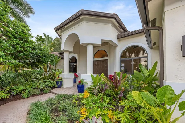 a front view of a house with swimming pool having outdoor seating