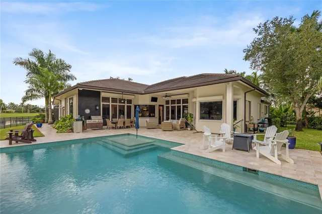 a view of a swimming pool with an outdoor seating and a mountain view