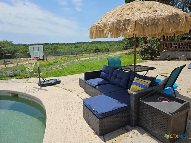 a view of a backyard with sitting area
