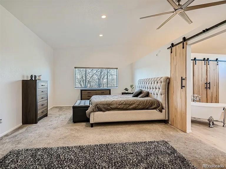 9910 Ammons Circle Westminster, CO 80021 - Photo 11 of 39 a bedroom with a bed and a chandelier