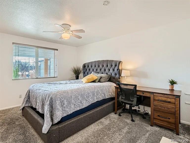 9910 Ammons Circle Westminster, CO 80021 - Photo 7 of 39 a bedroom with a bed and a chandelier