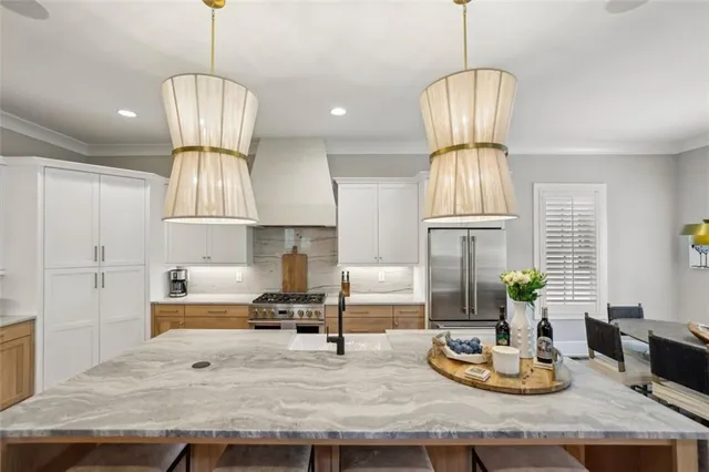 a kitchen with cabinets a sink stove and refrigerator