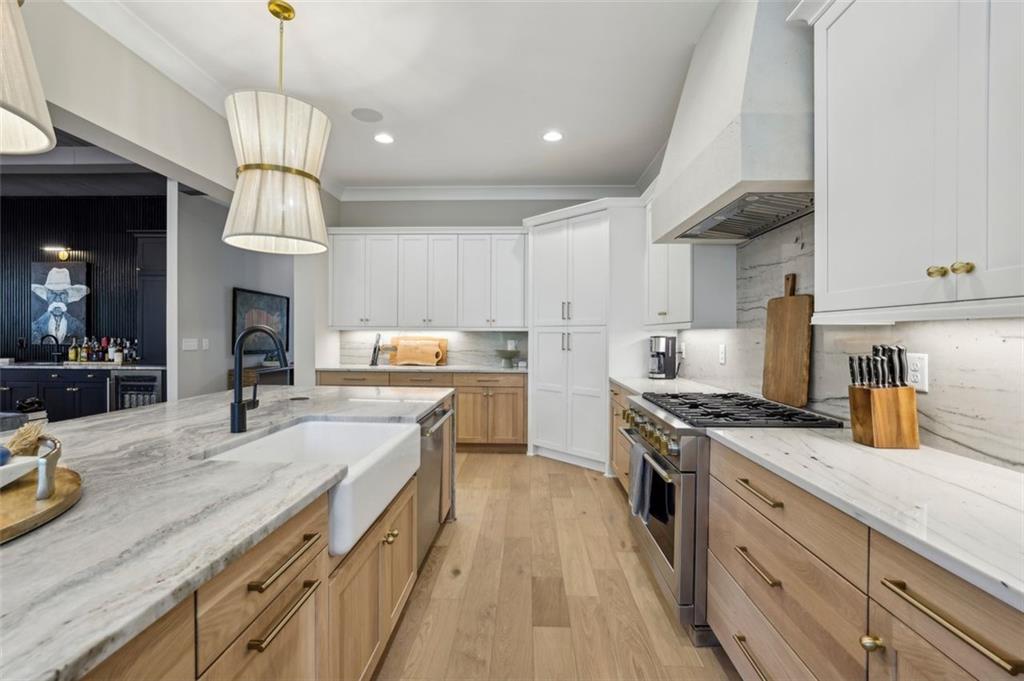 2591 Apple Valley Road Brookhaven, GA 30319 - Photo 16 of 31 a kitchen with a sink dishwasher a stove and a refrigerator with wooden floor