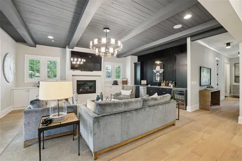 a living room with furniture and a book shelf