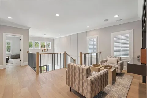 a spacious bedroom with a bed a dresser and a window