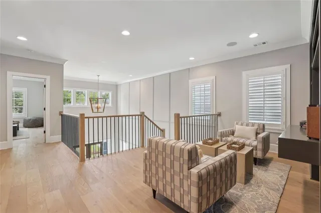 a spacious bedroom with a bed a dresser and a window