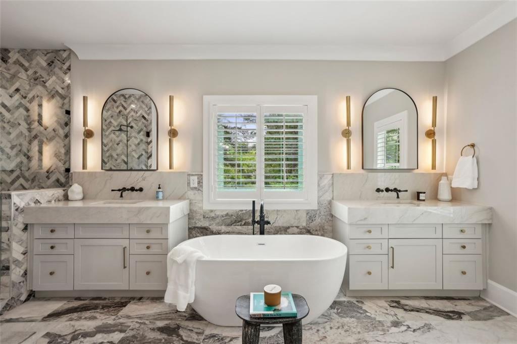 2591 Apple Valley Road Brookhaven, GA 30319 - Photo 21 of 31 a spacious bathroom with a double vanity sink a two mirror a window and a bathtub
