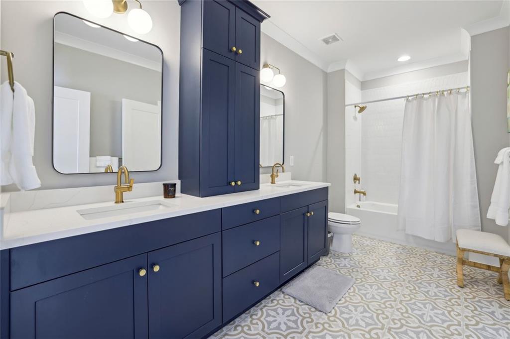 2591 Apple Valley Road Brookhaven, GA 30319 - Photo 29 of 31 a spacious bathroom with a double vanity sink toilet mirror and bathtub