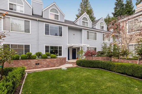 a front view of a house with a garden and yard