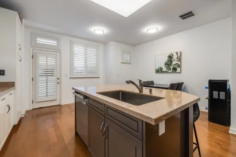 a kitchen that has a sink and a stove in it