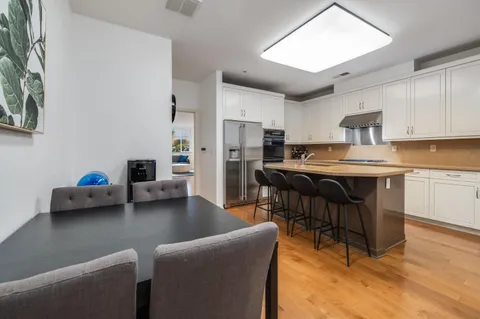 a living room with furniture and a kitchen counter space