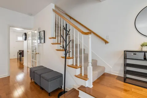 a view of entryway and hall with wooden floor