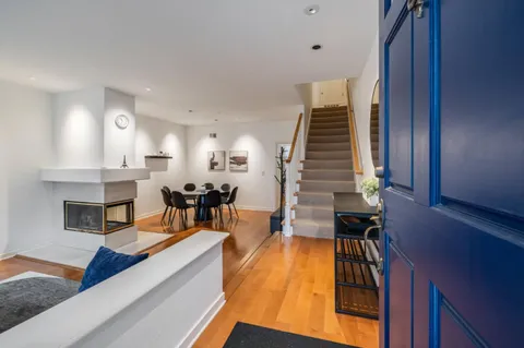 a living room with fireplace furniture and a wooden floor