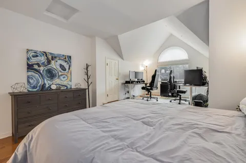 a bed room with a bed a mirror and gym equipment