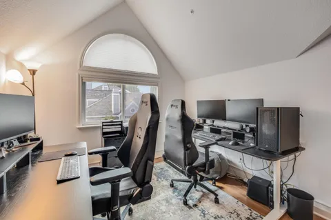 a view of a workspace with furniture and a flat screen tv