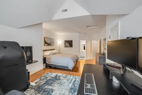 a bedroom with furniture and a flat screen tv