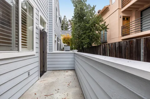 a view of balcony with wooden floor and fence