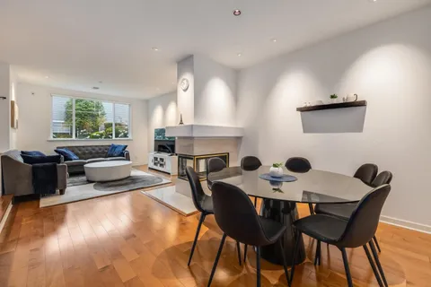a view of a dining room with furniture and a fireplace