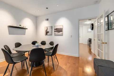 a view of a dining room with furniture and wooden floor
