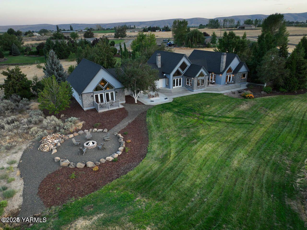 an aerial view of a house with garden space and street view