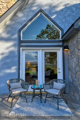 a bathroom with a toilet sink vanity granite and shower