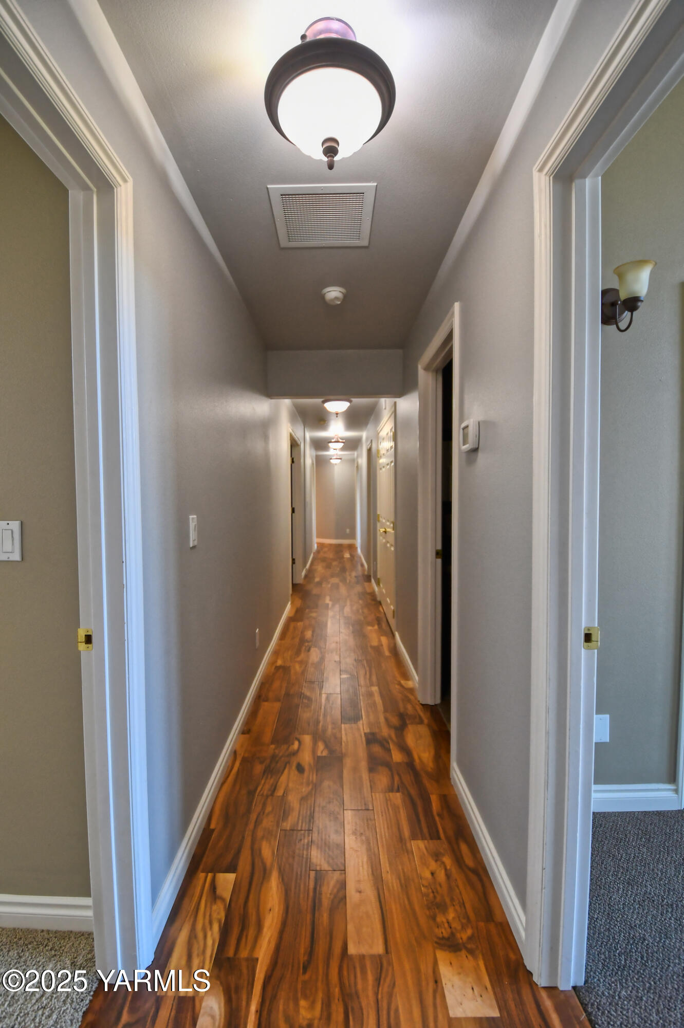 15783 Fisk Road Yakima, WA 98908 - Photo 36 of 61 a view of a hallway with wooden floor