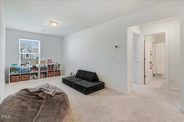 a view of a hallway with wooden floor and stairs