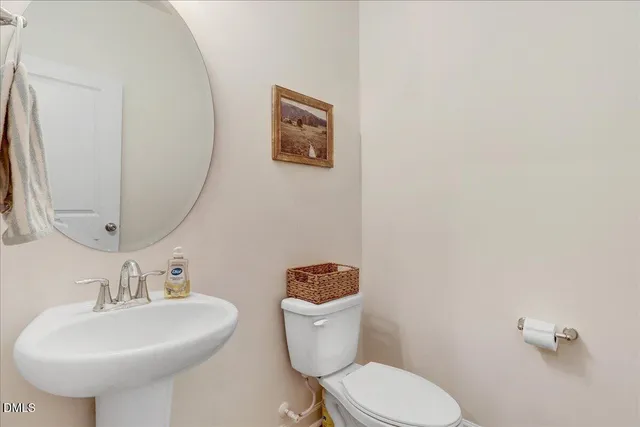 a bathroom with a granite countertop sink toilet a mirror and shower