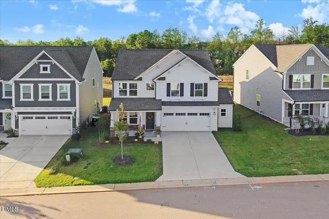 an aerial view of residential houses with outdoor space and swimming pool