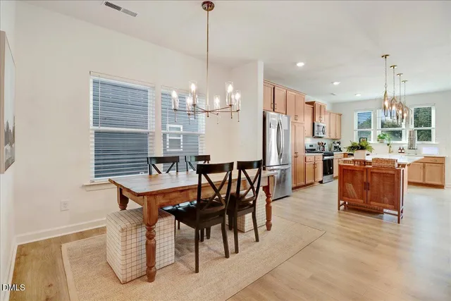 a front view of a house with a garden and plants